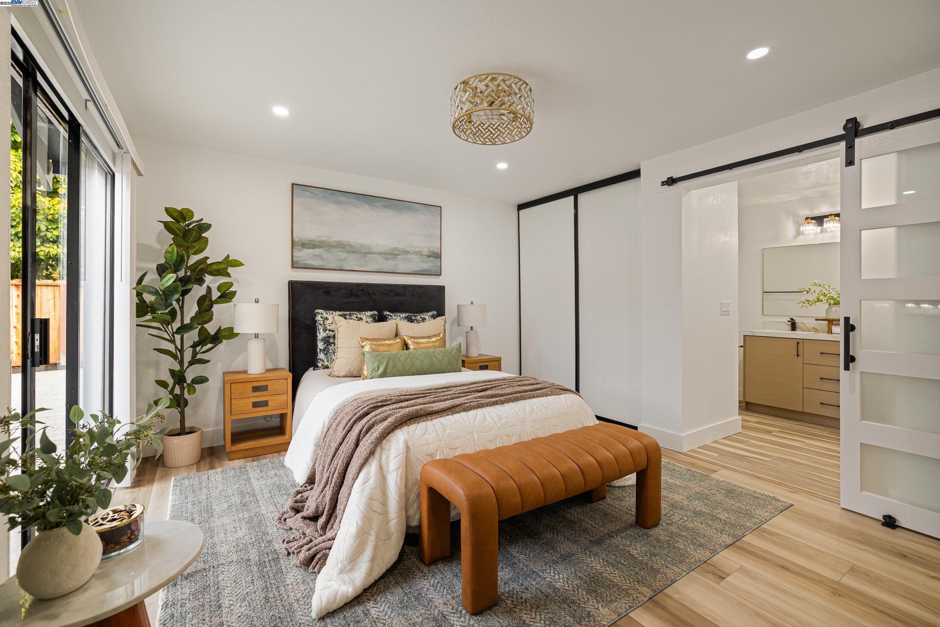 713 Sandy Brook Court Rodeo, CA 94572 - Photo 21 of 36 a bedroom with a large bed and a potted plant