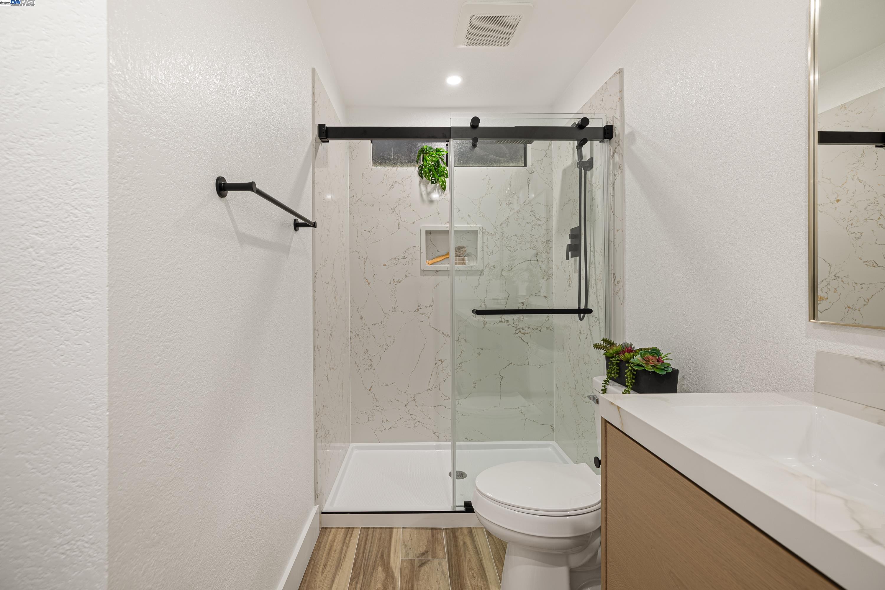713 Sandy Brook Court Rodeo, CA 94572 - Photo 26 of 36 a bathroom with a shower a toilet and a sink