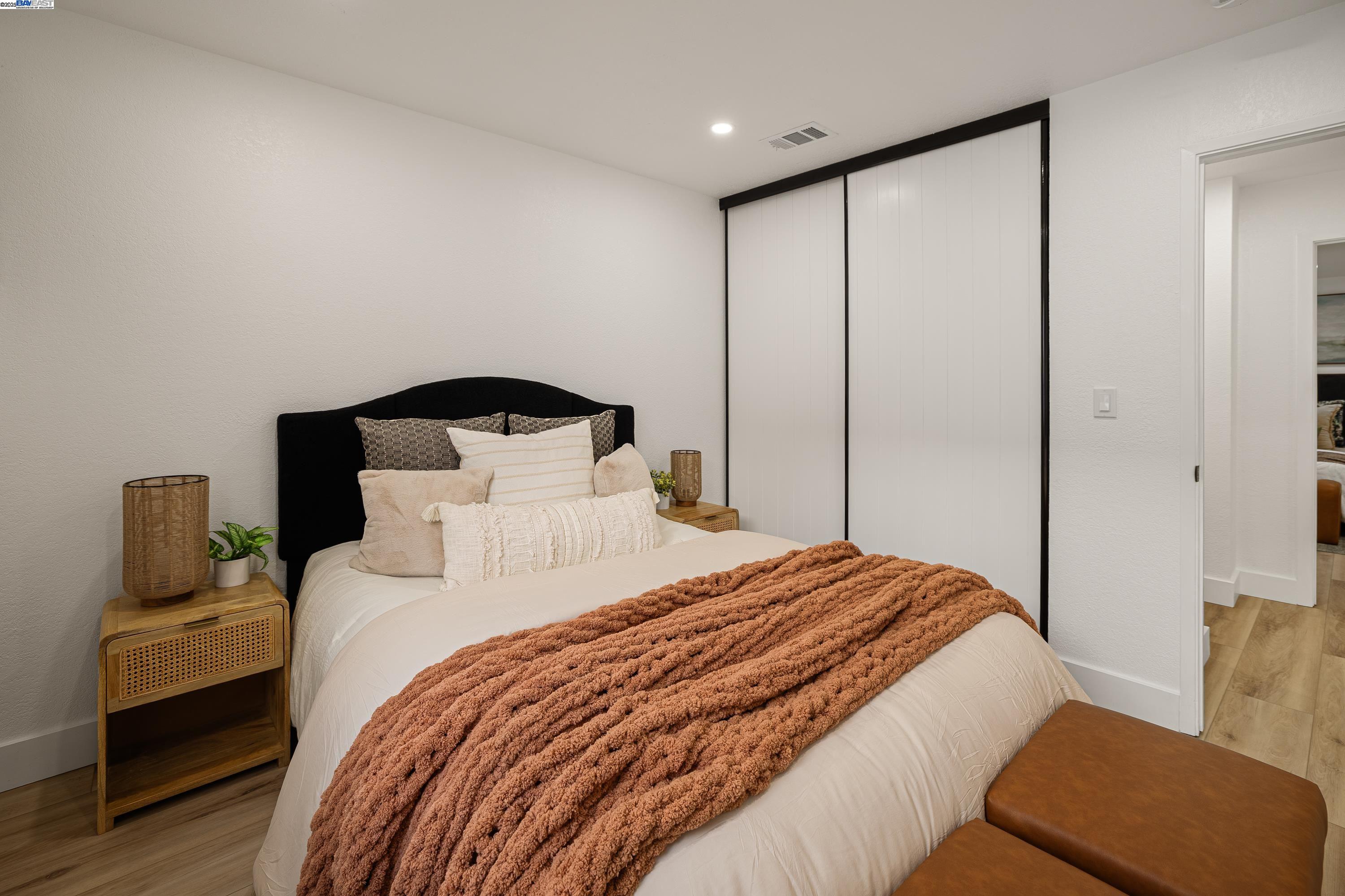 713 Sandy Brook Court Rodeo, CA 94572 - Photo 27 of 36 a bedroom with a large bed and a couch