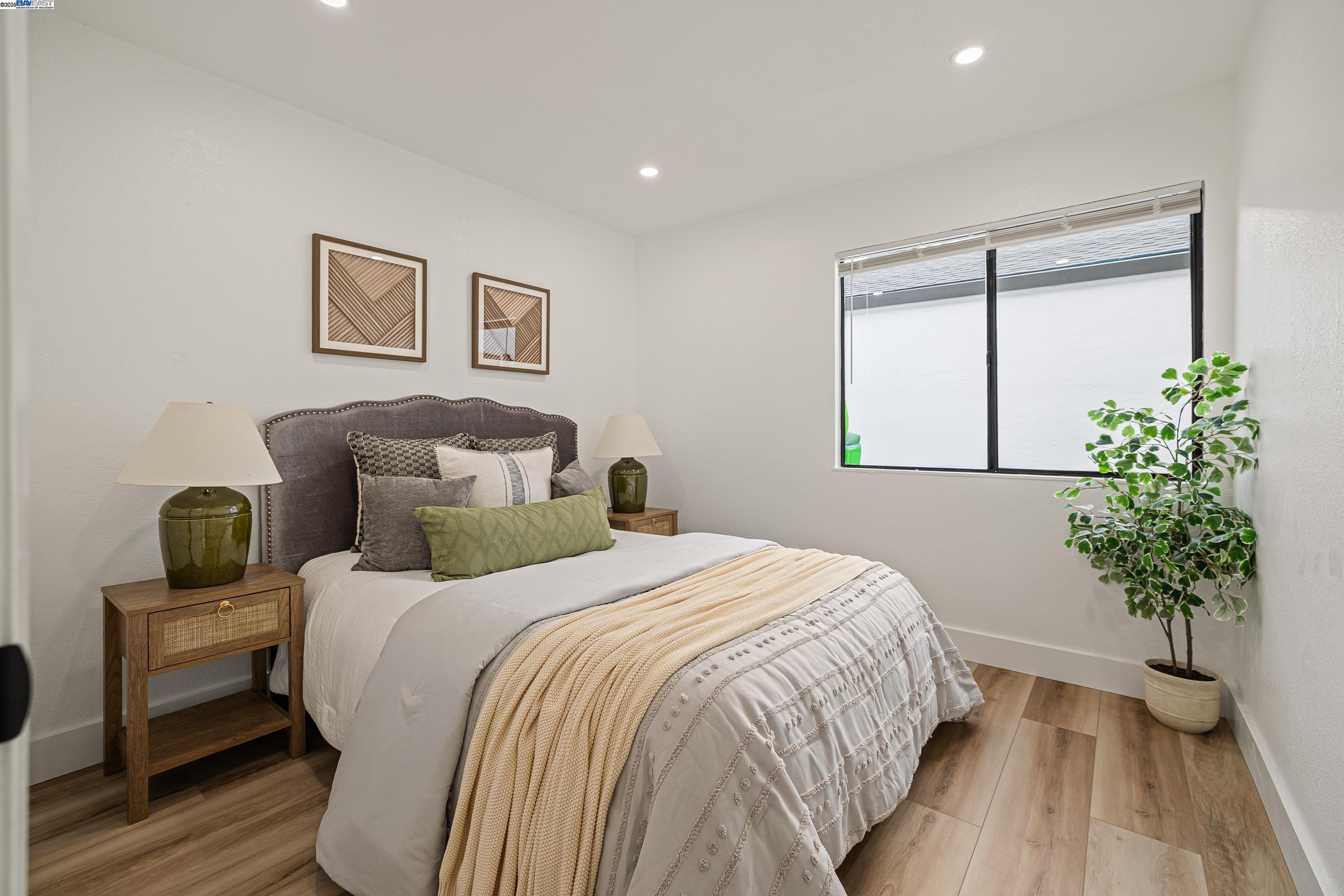 713 Sandy Brook Court Rodeo, CA 94572 - Photo 28 of 36 a bedroom with a large bed and a potted plant