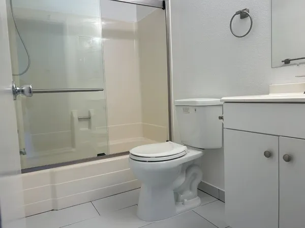 a bathroom with a toilet and shower