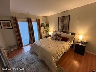 3328 Windermere Drive Bushkill, PA 18324 - Photo 15 of 33 a bedroom with a bed and a flat tv screen on dresser