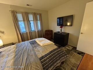3328 Windermere Drive Bushkill, PA 18324 - Photo 16 of 33 a bedroom with a bed and a flat screen tv