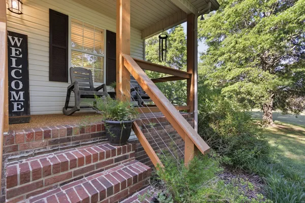 a view of balcony with wooden floor and fence