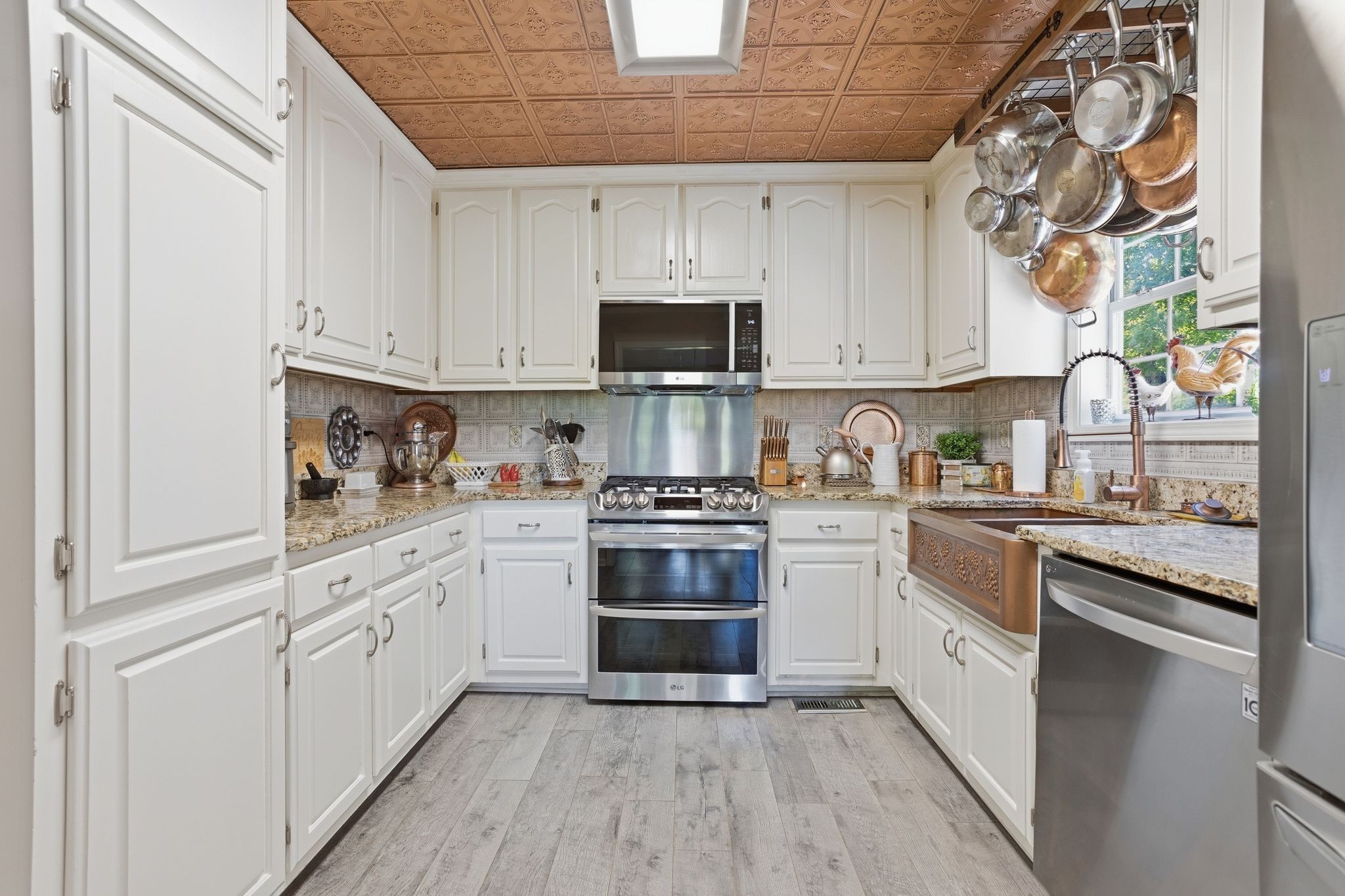 1038 South Cross Bridges Road Mount Pleasant, TN 38474 - Photo 12 of 39 a kitchen with cabinets stainless steel appliances and a window