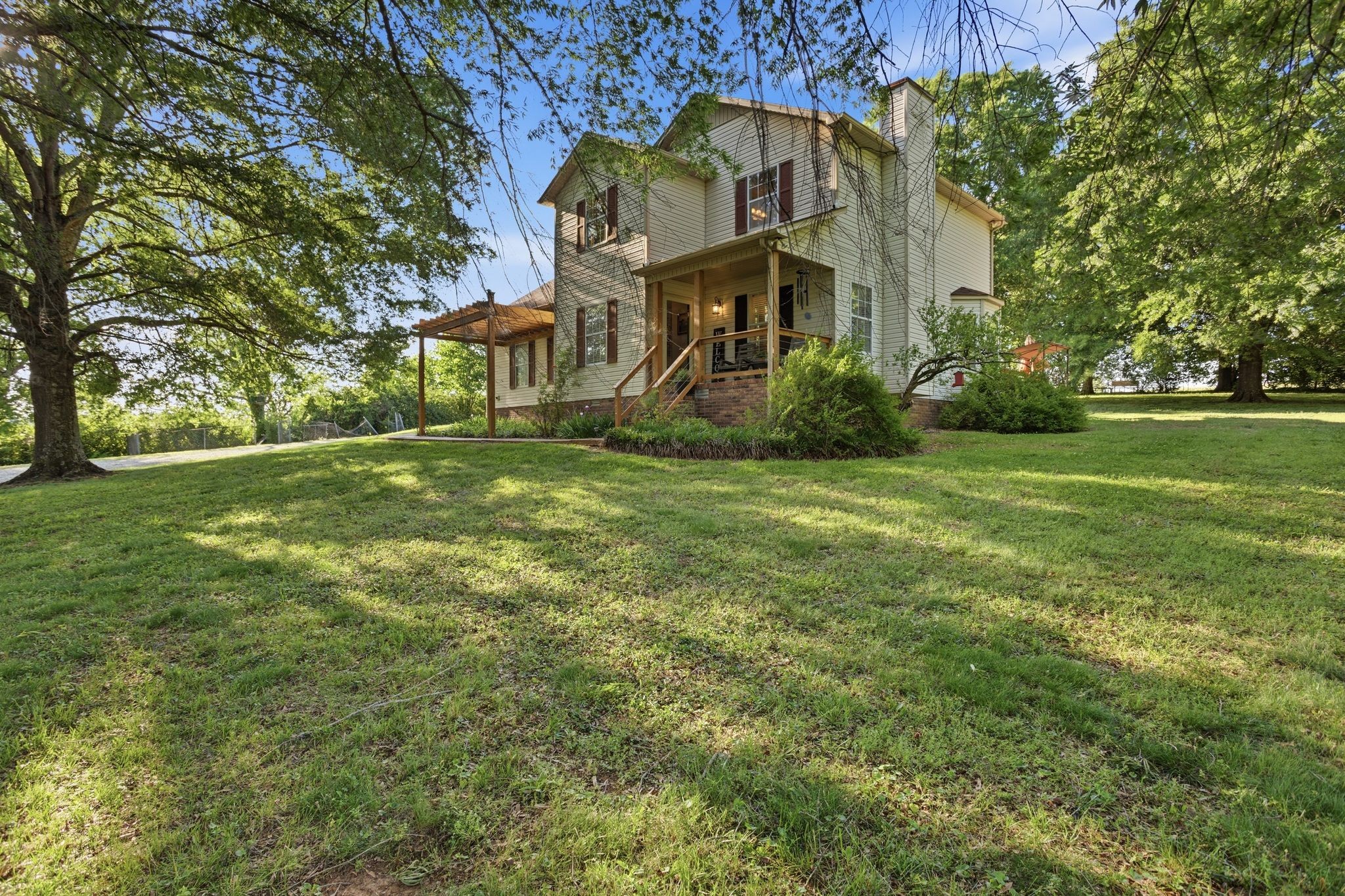 1038 South Cross Bridges Road Mount Pleasant, TN 38474 - Photo 36 of 39 a view of a big house with a big yard and large trees