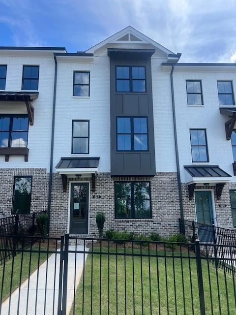 629 Silva Street, Unit 128 Cumming, GA 30040 - Photo 1 of 54 a front view of a house with a garden