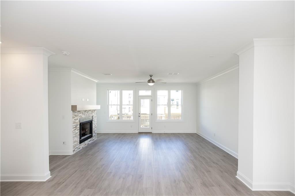 629 Silva Street, Unit 128 Cumming, GA 30040 - Photo 11 of 54 an empty room with windows and a fireplace