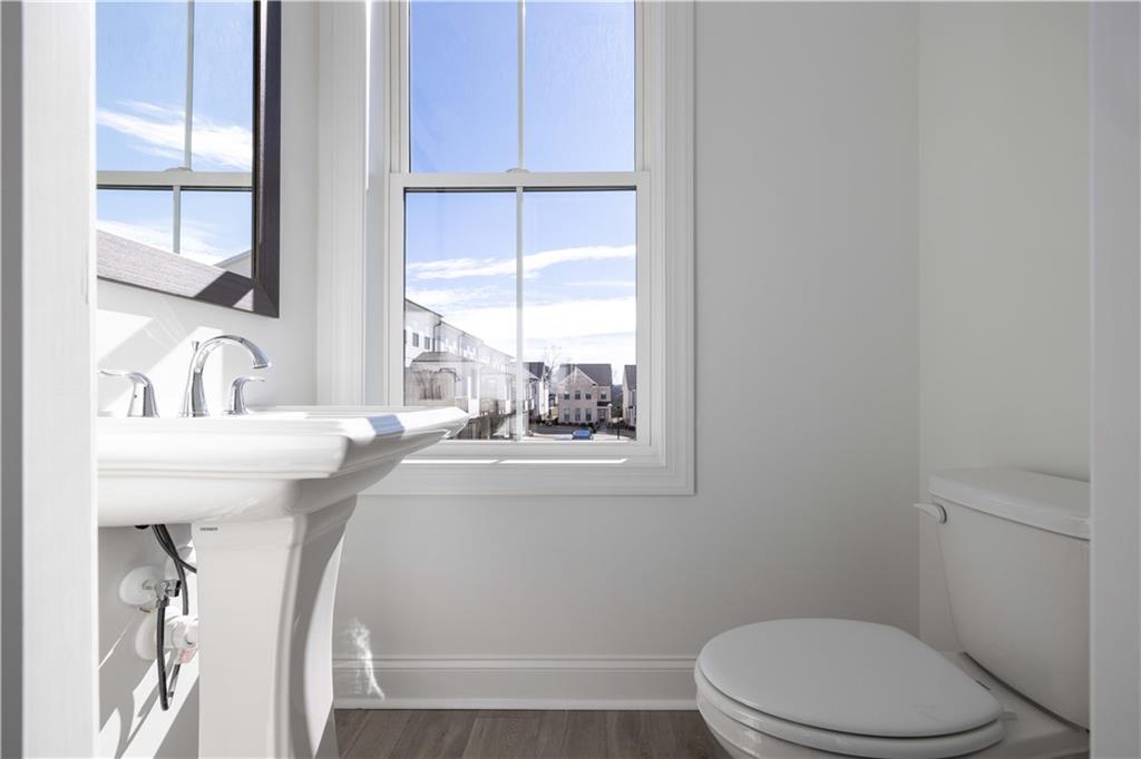 629 Silva Street, Unit 128 Cumming, GA 30040 - Photo 14 of 54 a bathroom with a sink a toilet and tub