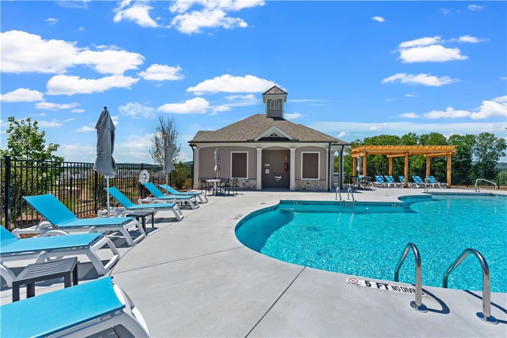 629 Silva Street, Unit 128 Cumming, GA 30040 - Photo 32 of 54 a view of a house with swimming pool and sitting area