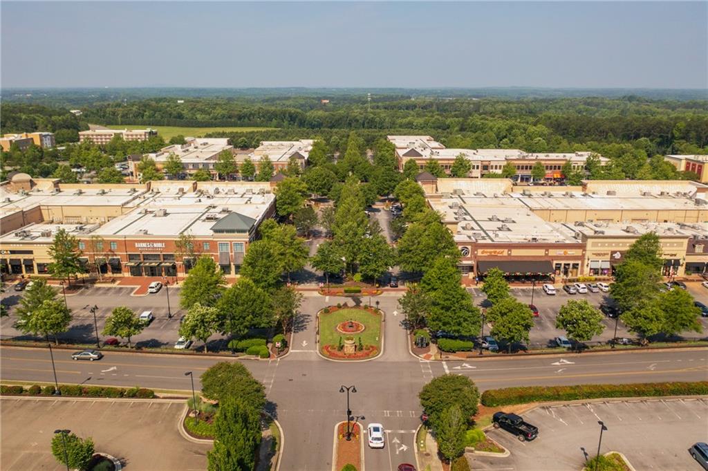 629 Silva Street, Unit 128 Cumming, GA 30040 - Photo 41 of 54 an aerial view of residential building and lake