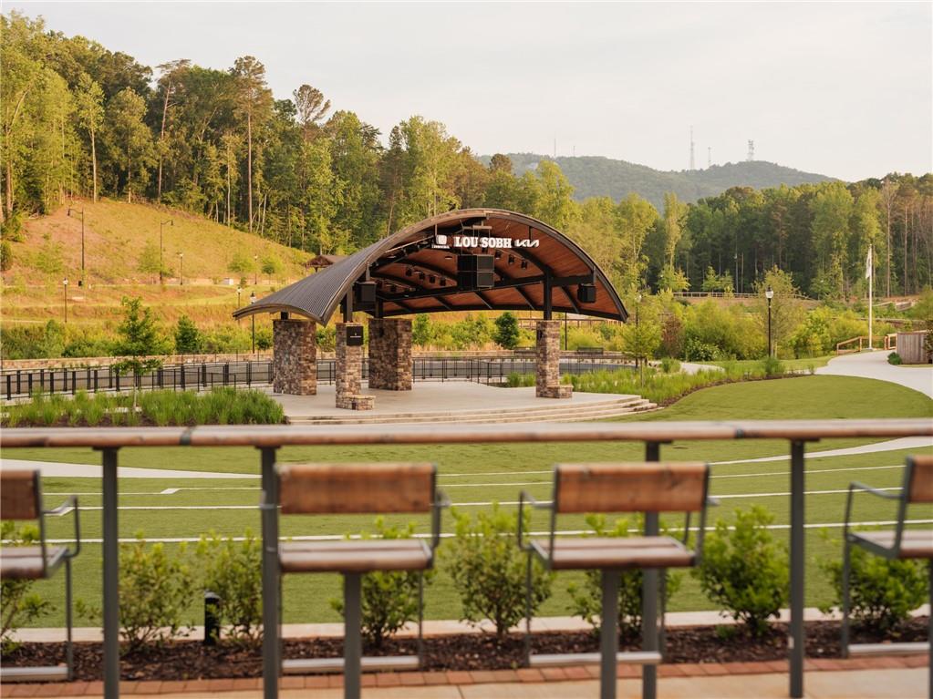 629 Silva Street, Unit 128 Cumming, GA 30040 - Photo 42 of 54 a view of a swimming pool with a lawn chairs under an umbrella