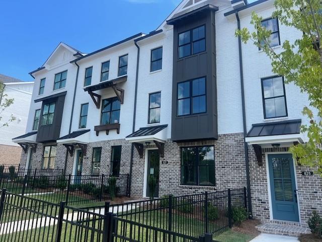 629 Silva Street, Unit 128 Cumming, GA 30040 - Photo 5 of 54 a front view of a house with a porch