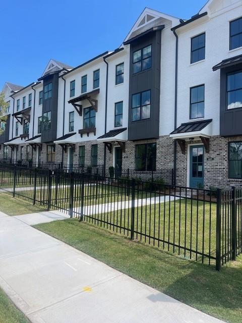 629 Silva Street, Unit 128 Cumming, GA 30040 - Photo 54 of 54 a front view of a house with a garden
