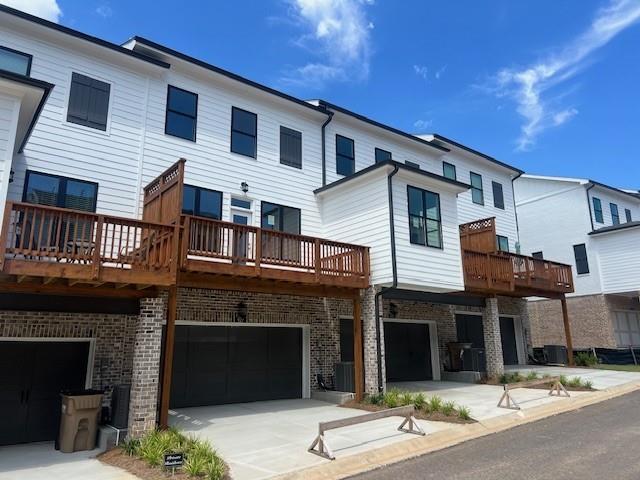 629 Silva Street, Unit 128 Cumming, GA 30040 - Photo 6 of 54 a front view of a house with a garage