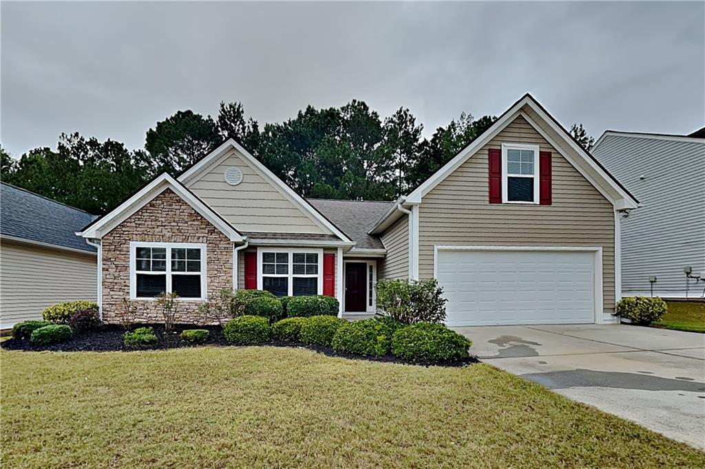 3762 Plymouth Rock Drive Loganville, GA 30052 - Photo 1 of 28 a front view of a house with a yard and garage