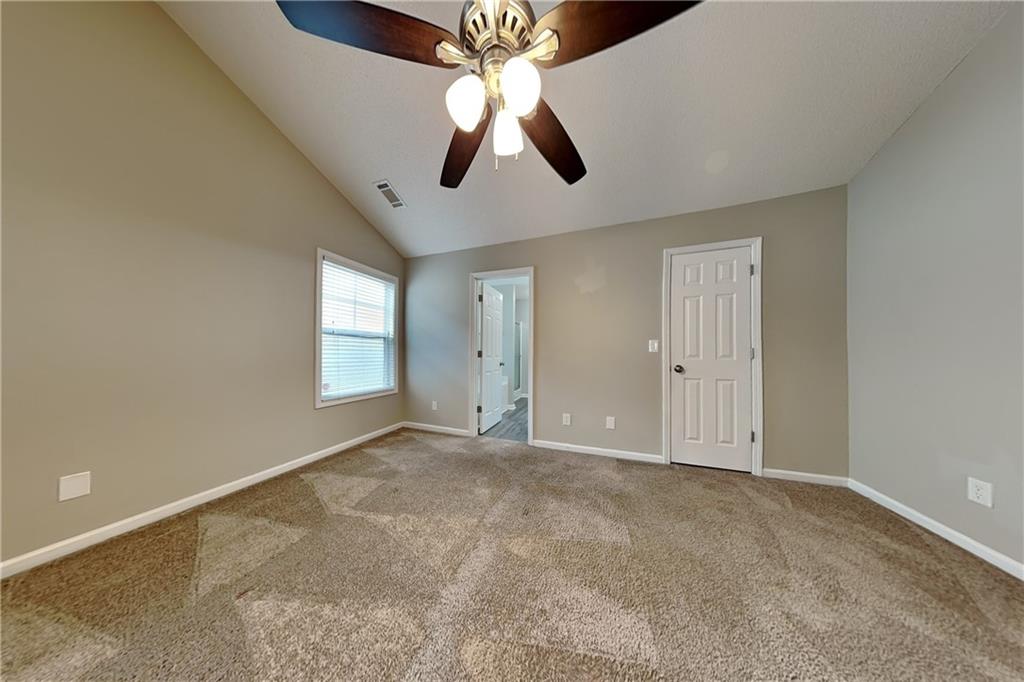 3762 Plymouth Rock Drive Loganville, GA 30052 - Photo 11 of 28 an empty room with windows and fan