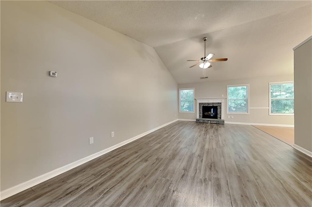 3762 Plymouth Rock Drive Loganville, GA 30052 - Photo 2 of 28 wooden floor in an empty room with a window