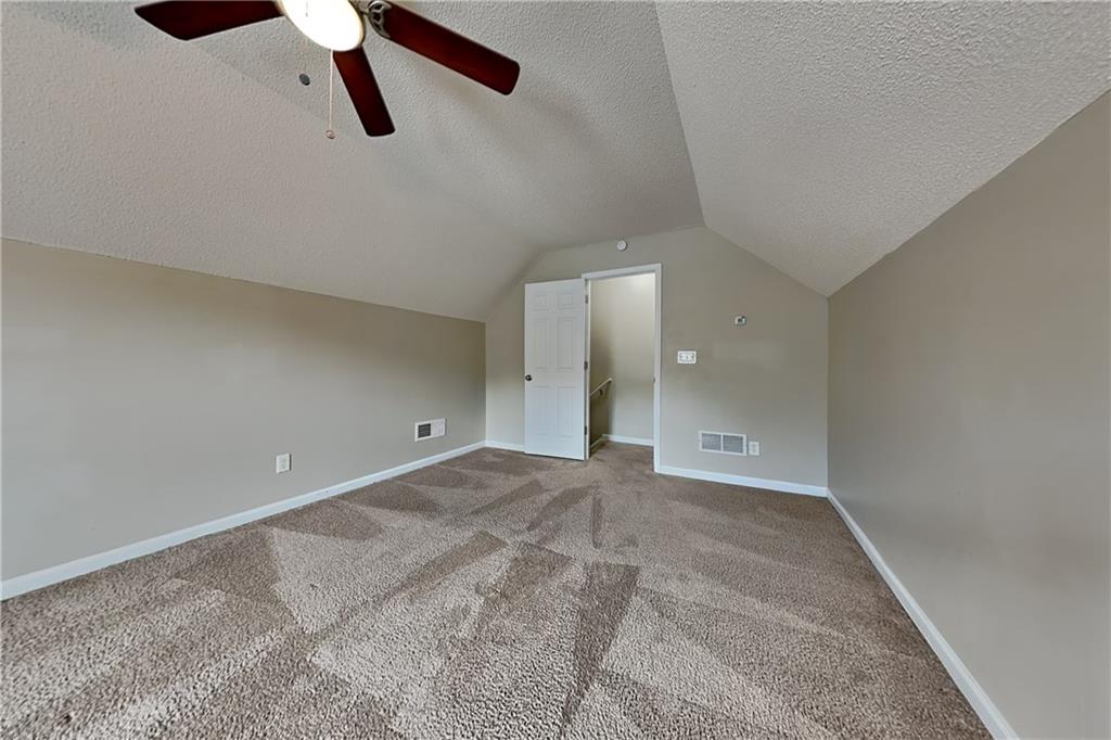 3762 Plymouth Rock Drive Loganville, GA 30052 - Photo 23 of 28 a view of a room with a ceiling fan and window