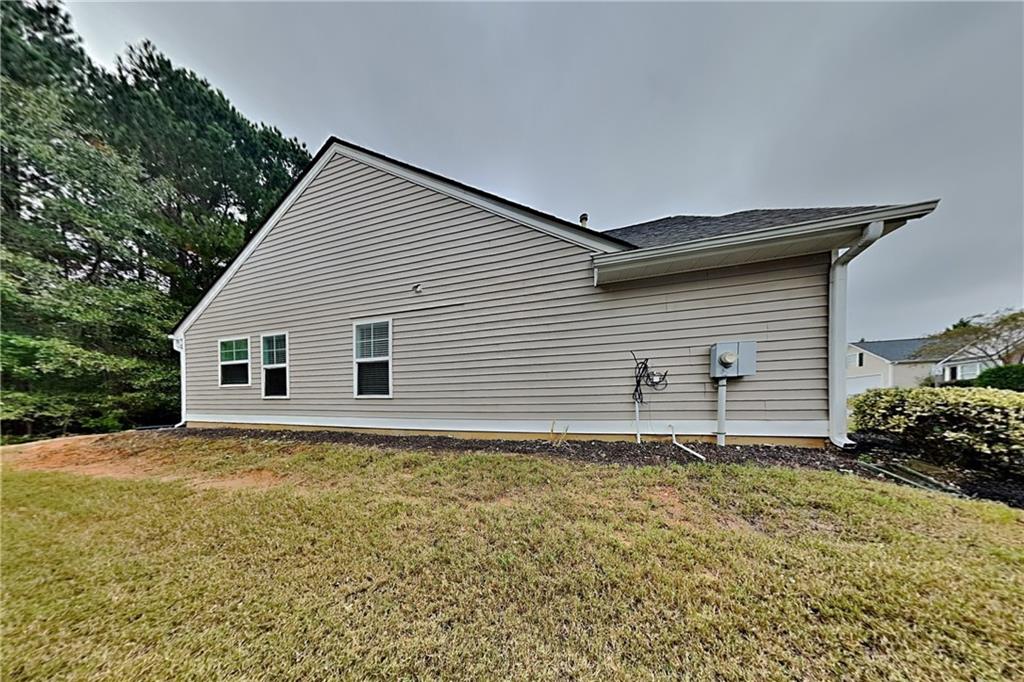 3762 Plymouth Rock Drive Loganville, GA 30052 - Photo 25 of 28 a house with a small yard and garden space