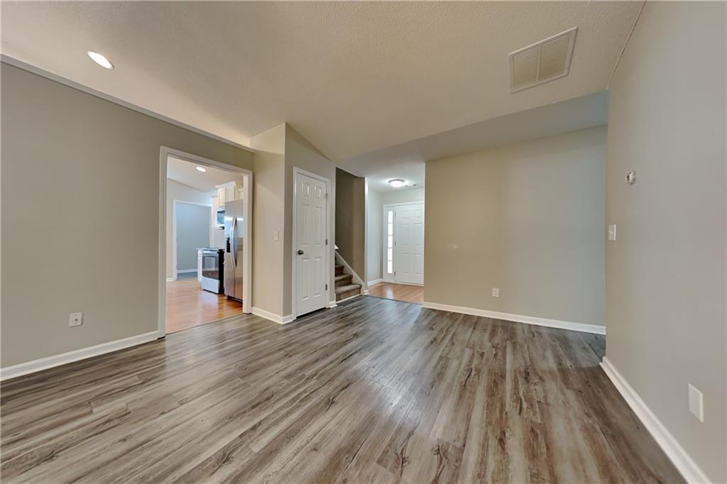 3762 Plymouth Rock Drive Loganville, GA 30052 - Photo 3 of 28 wooden floor in an empty room with a window
