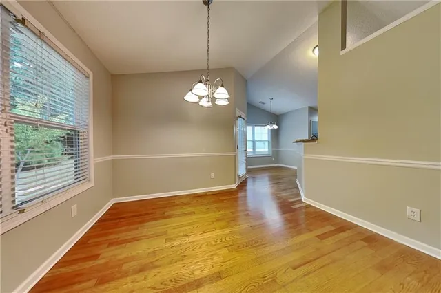 a view of a room with wooden floor and large windows