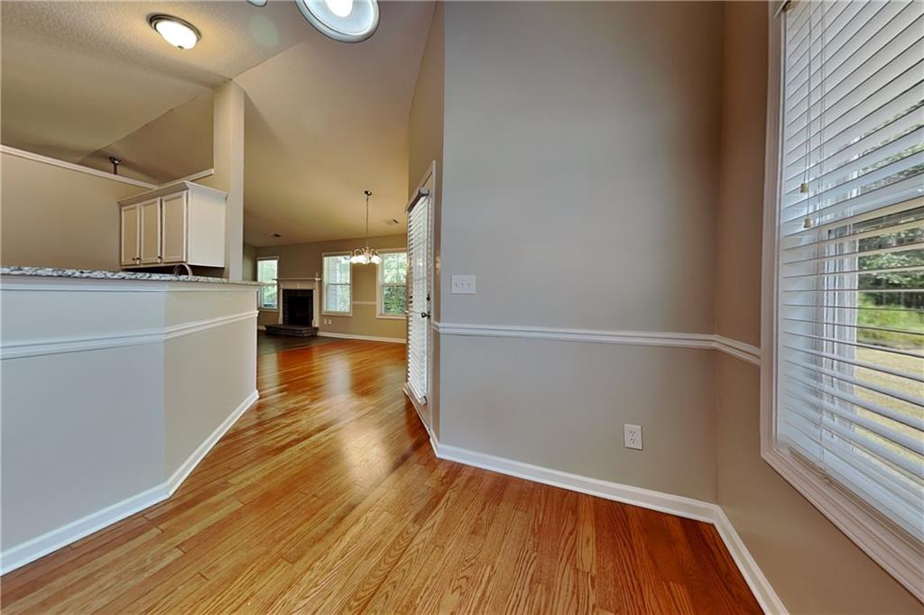 3762 Plymouth Rock Drive Loganville, GA 30052 - Photo 10 of 28 wooden floor in an empty room with a window