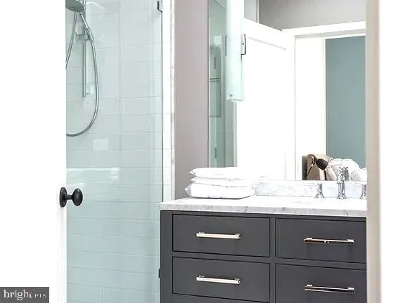 a bathroom with a sink vanity and a mirror