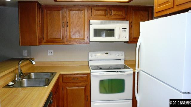 4235 Baker Lane Reno, NV 89509 - Photo 2 of 10 a kitchen with granite countertop a sink and a stove top oven
