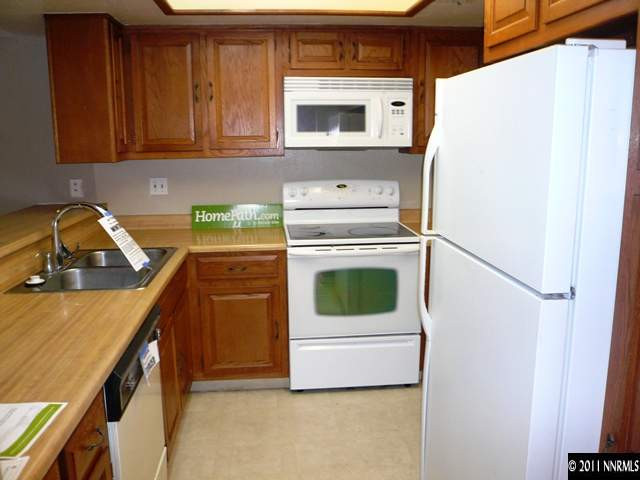 4235 Baker Lane Reno, NV 89509 - Photo 9 of 10 a kitchen with a stove microwave and refrigerator