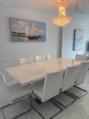 a living room with a table and chandelier