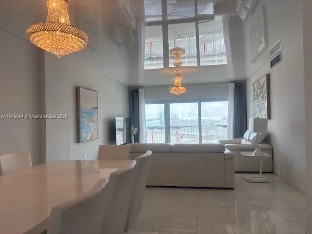 a living room with furniture and a chandelier