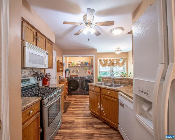 a kitchen with stove a sink and cabinets