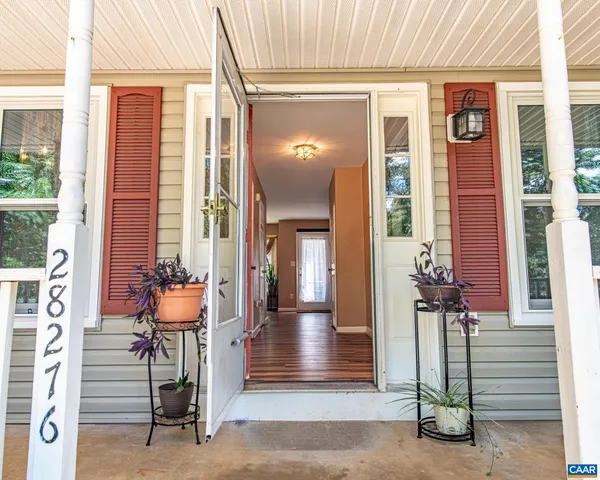 a view of an entryway of house with wooden floor
