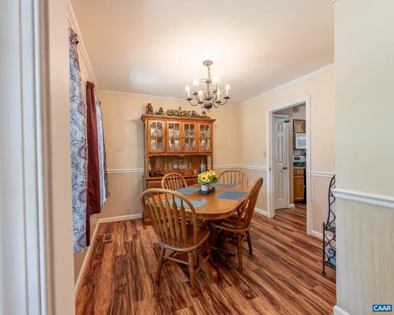 a view of a dining room with furniture and chandelier