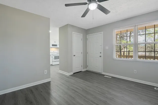 wooden floor in an empty room with a window