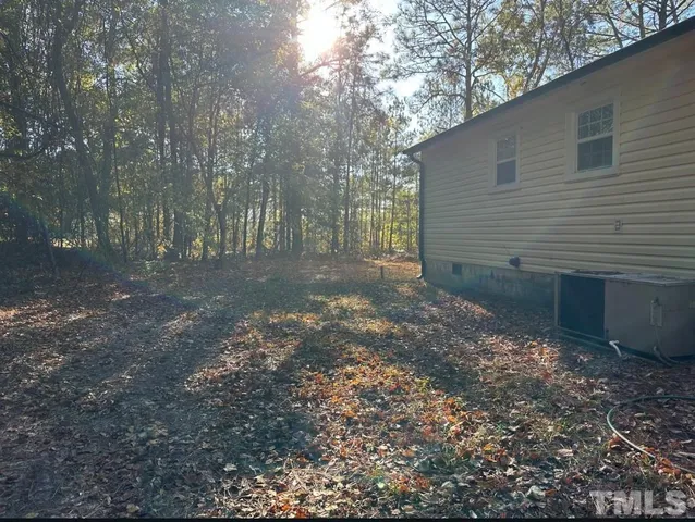 a view of a backyard with large trees