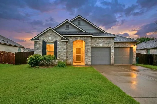 a front view of a house with yard