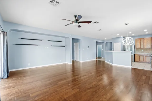 a view of a kitchen with wooden floor and a window