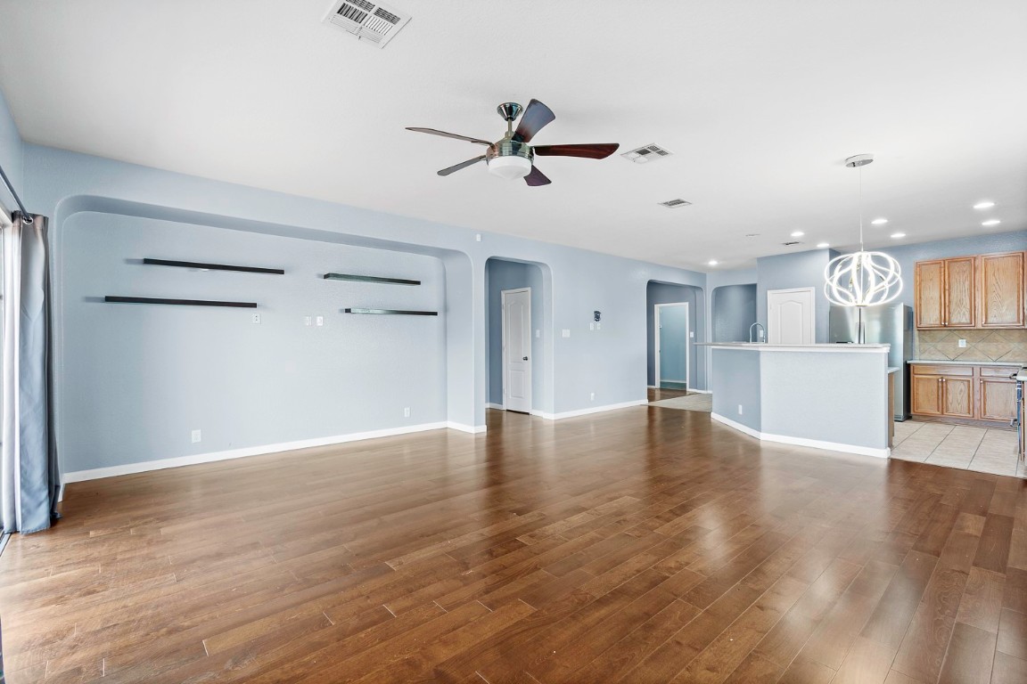 345 Apricot Drive Kyle, TX 78640 - Photo 11 of 37 a view of a kitchen with wooden floor and a window