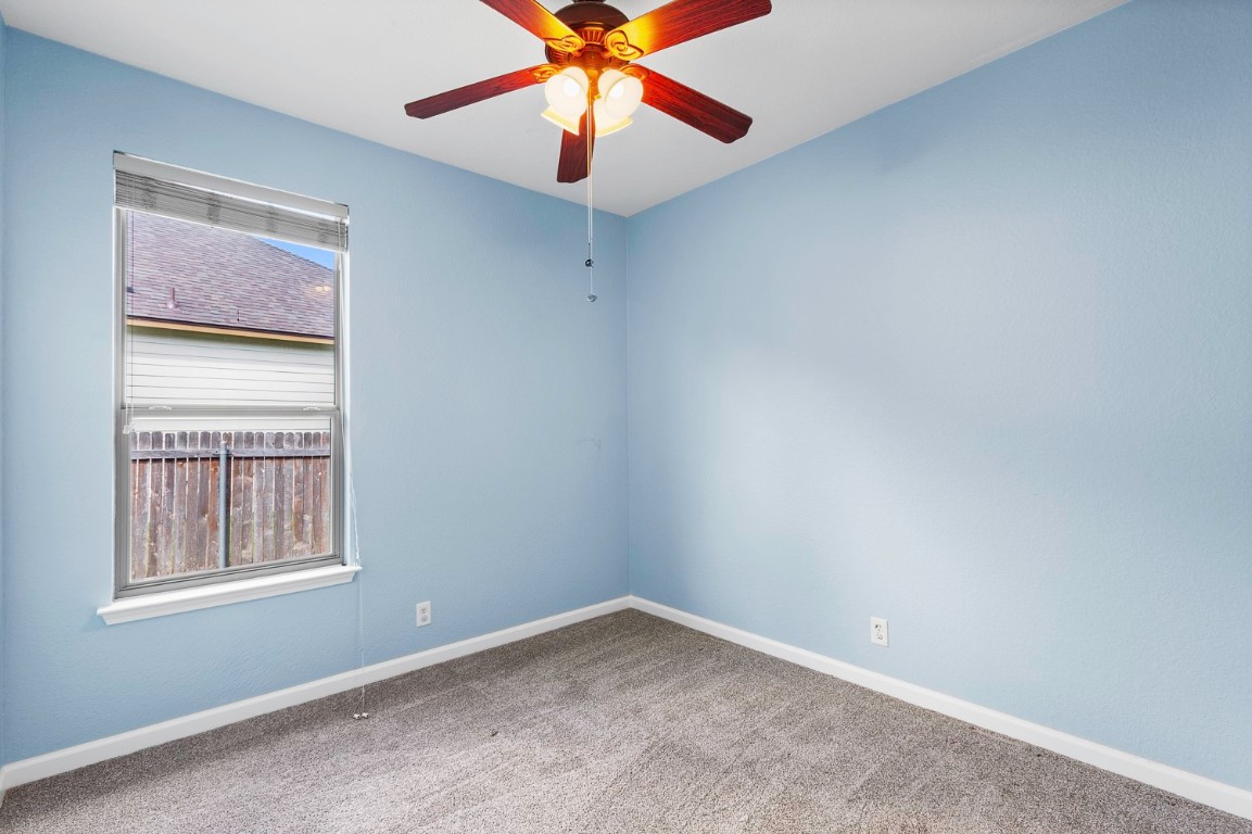 345 Apricot Drive Kyle, TX 78640 - Photo 22 of 37 an empty room with a window and a fan