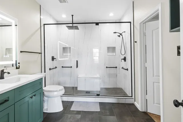 a bathroom with a shower toilet and sink