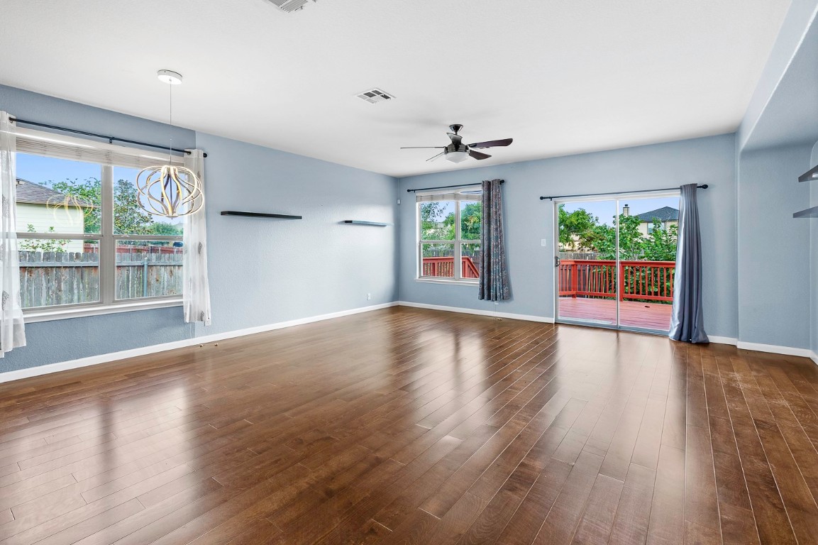 345 Apricot Drive Kyle, TX 78640 - Photo 7 of 37 a view of an empty room with wooden floor and a window