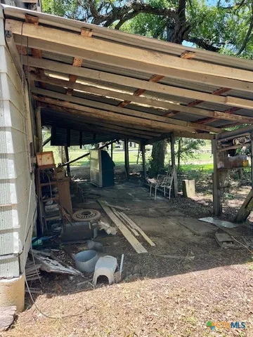 a view of a patio with table and chairs