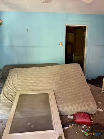 a bedroom with a bed and a rug