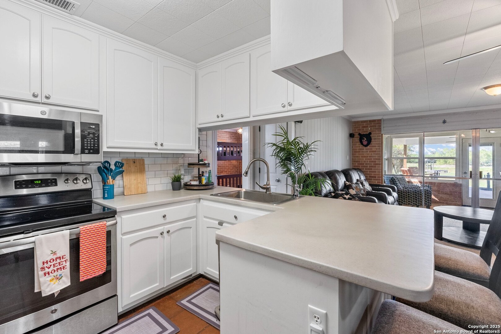 180 Freeman Circle George West, TX 78022 - Photo 11 of 41 a kitchen with a sink a stove and cabinets