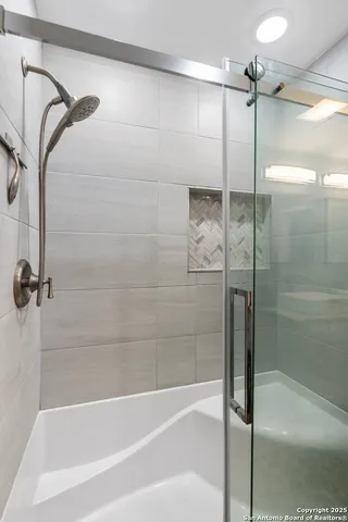 a bathroom with a bathtub and a shower