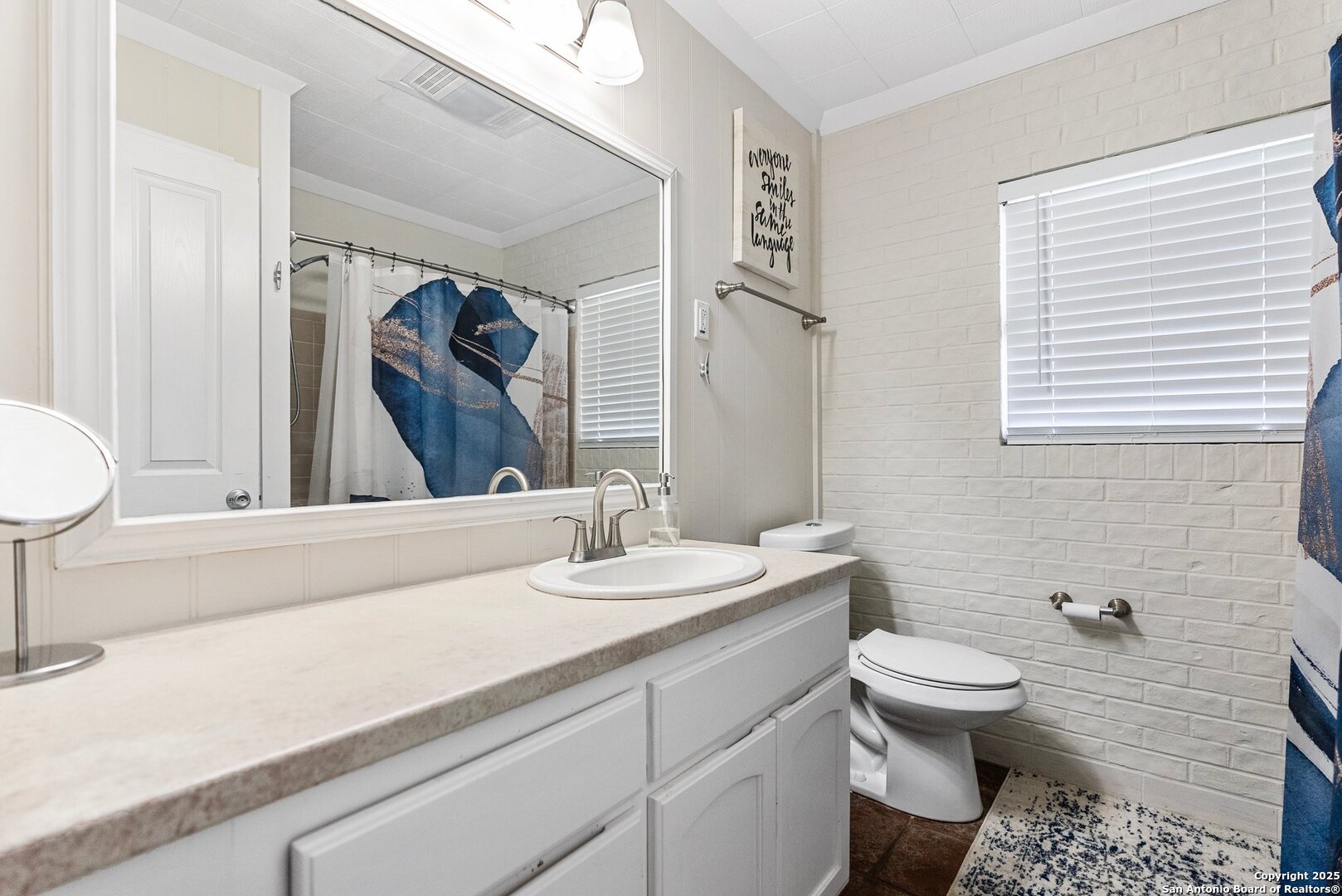 180 Freeman Circle George West, TX 78022 - Photo 20 of 41 a bathroom with a toilet sink and mirror
