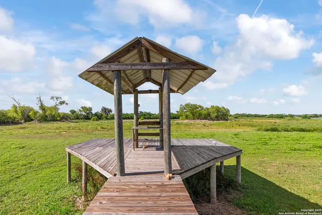 a view of a wooden deck with a yard