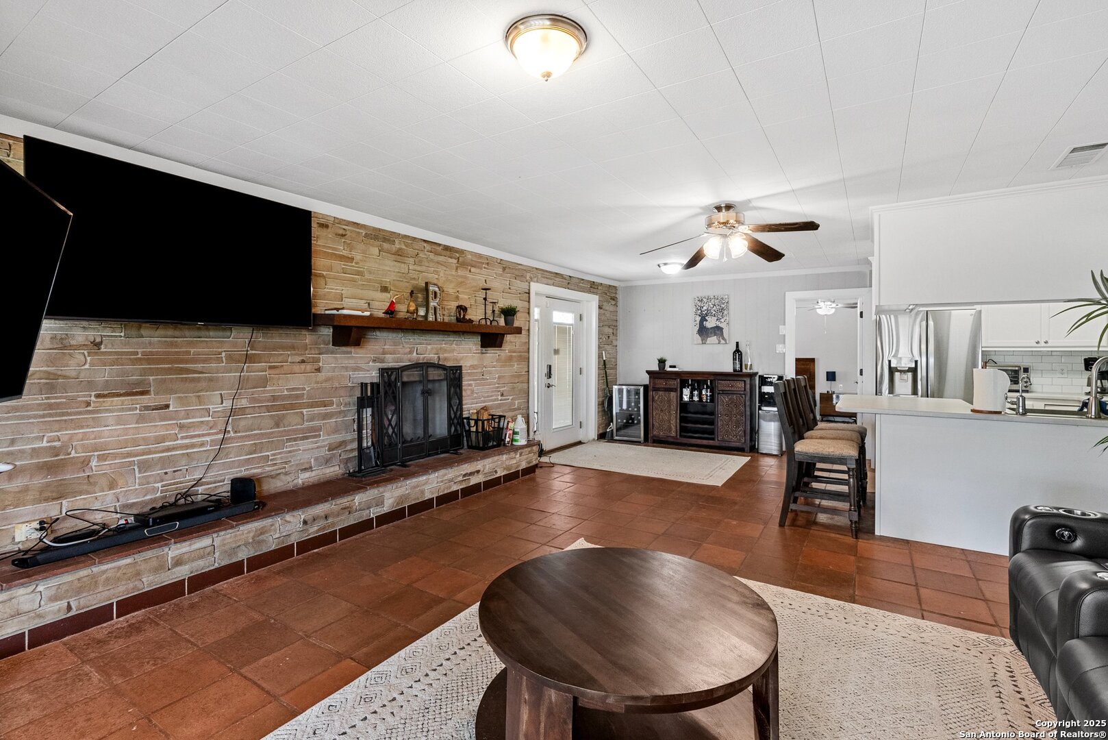 180 Freeman Circle George West, TX 78022 - Photo 5 of 41 a living room with furniture a flat screen tv and a fireplace